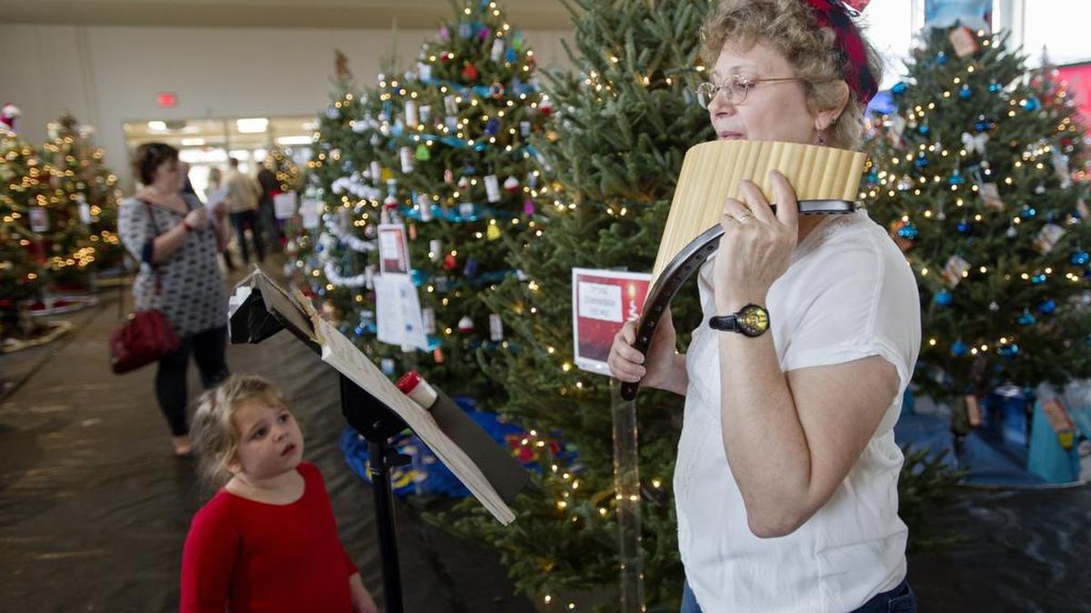 Ellen Singerland plays holiday tunes on the pan flute during the Centre County United Way Festival of Trees at the Central Pennsylvania Institute of Science and Technology on Saturday.
