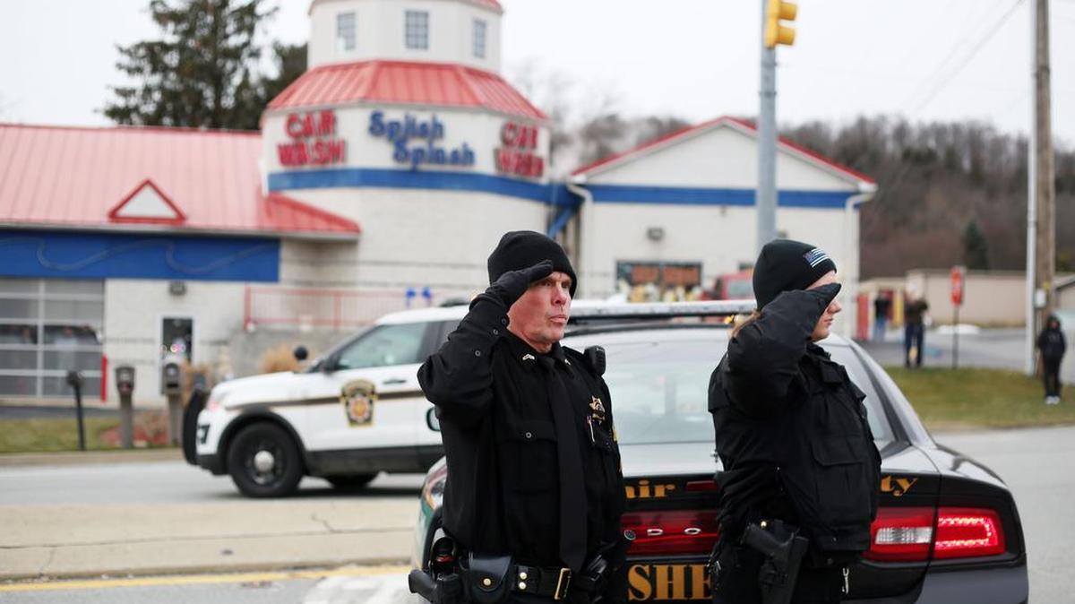 Blair County Cpl. Tim Mearkle, left, and Deputy April Wise salute the funeral procession for Trooper Landon Weaver as it travels down Plank Road Altoona in 2016. Weaver was killed in the line of duty.