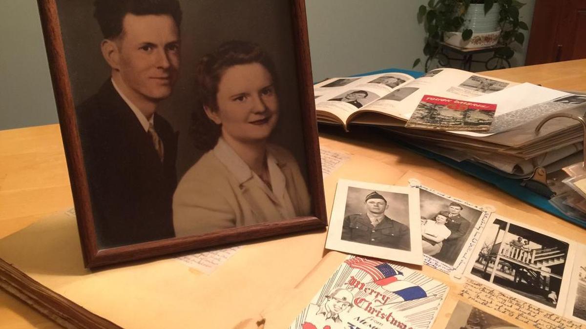 Willard “Bill” Shore and his wife, Thelma “Selmie” Shore, are pictured next to a scrapbook of his wartime letters and photos.