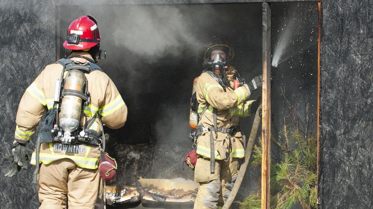 Orange County Fire Authority firefighters douse a staged Christmas tree fire during a holiday safety demonstration on Dec. 12 in Irvine, Calif.