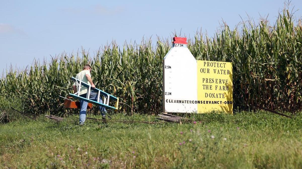 Jay Aubuchon sets up to fill in the rest of the billboard Tuesday along University Drive, to reflect that ClearWater Conservancy has reached its fundraising goal for its Slab Cabin Run Initiative. The more than 300 acres of agricultural land will now be permanently conserved.