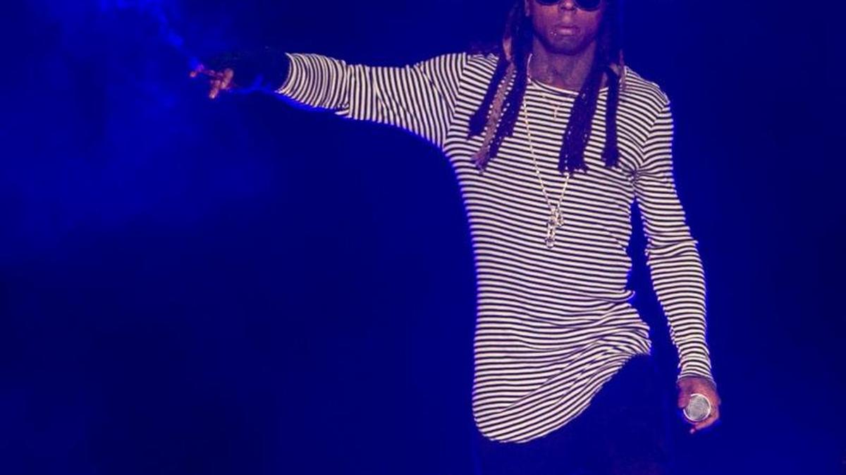 Lil Wayne walks on stage smoking during his “The Dedication Tour” on Saturday at the Bryce Jordan Center.