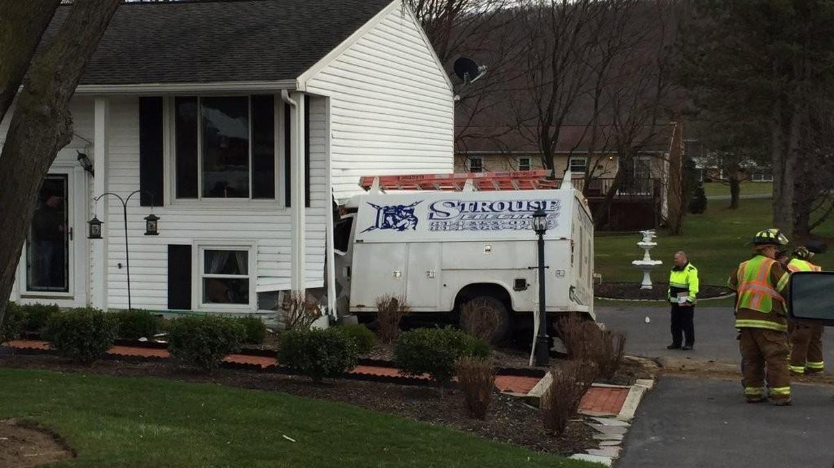 A service truck crashed into a home Friday