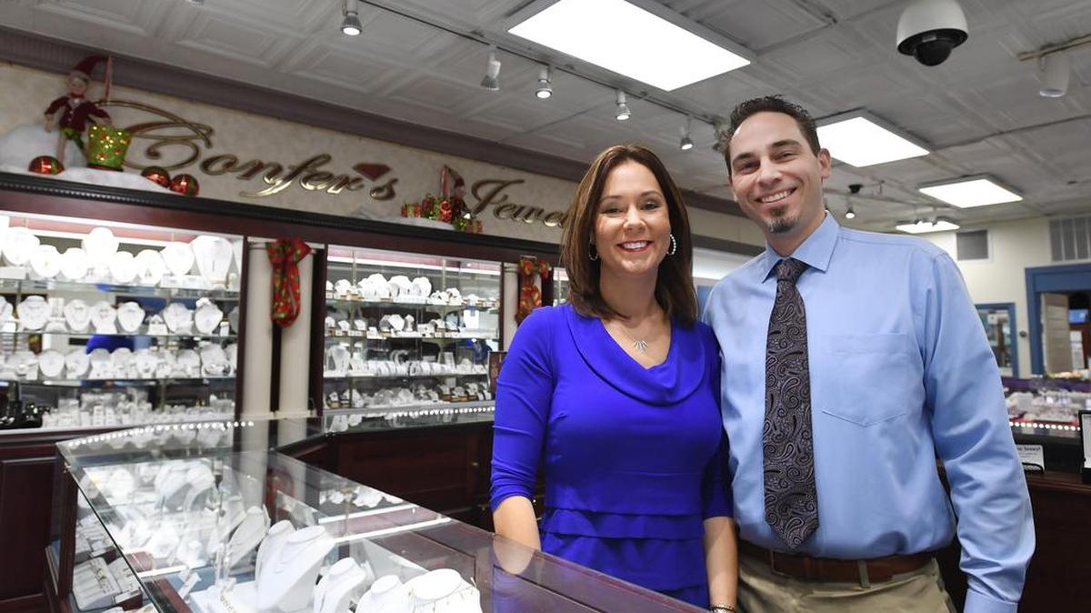Monteca Confer Beisel and her husband Daniel Beisel pose for a photo Tuesday at Confer’s Jewelers in Bellefonte.