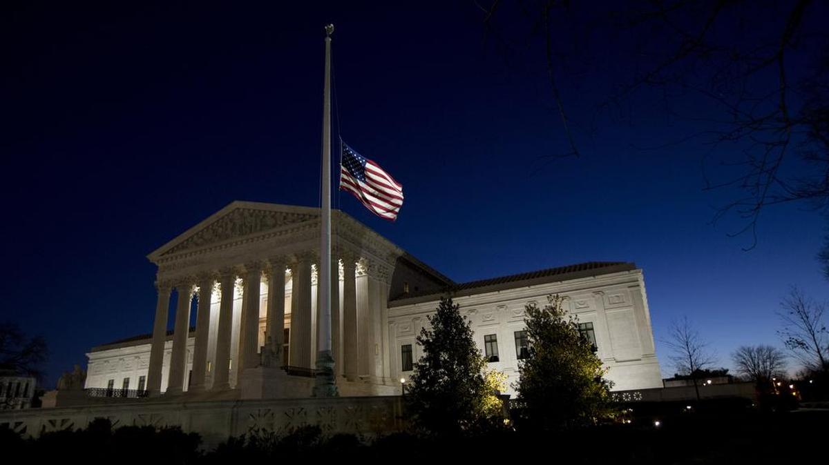 An American flag flies at half-staff in front of the U.S. Supreme Court building in honor of Supreme Court Justice Antonin Scalia as the sun rises in Washington on Sunday. Scalia, the influential conservative and most provocative member of the Supreme Court, has died. He was 79.