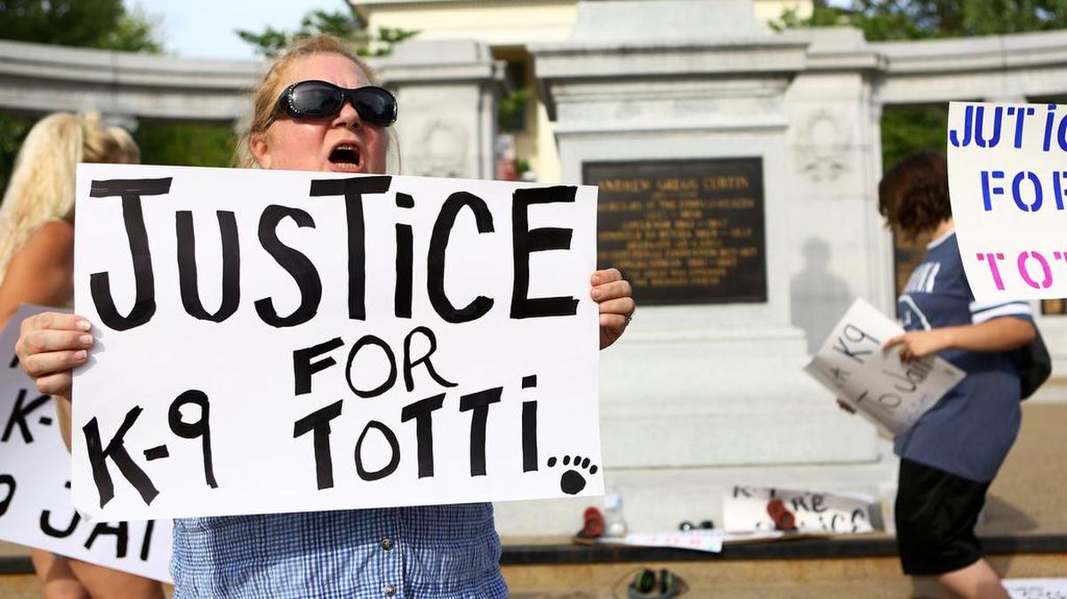 People gather at the Centre County Courthouse in July to protest the death of Totti, a Department of Corrections drug interdiction unit dog.