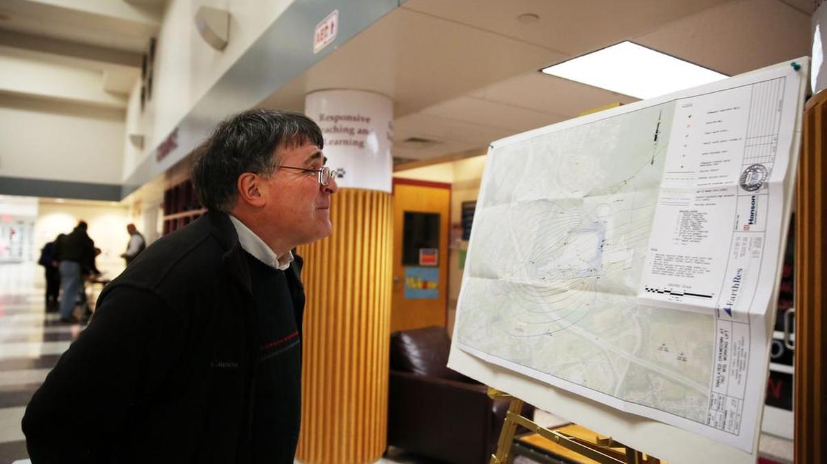 Andrew Sicree views a map of the quarry during a public hearing on the Oak Hall Quarry expansion application on Friday at Mount Nittany Middle School.