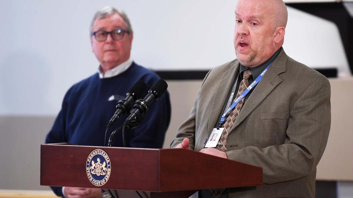 Steve Bekanich, PEMA director of the Bureau of Recovery and Mitigation, right, speaks during a news conference for flood insurance and grant funding Monday at the Milesburg Community Center.