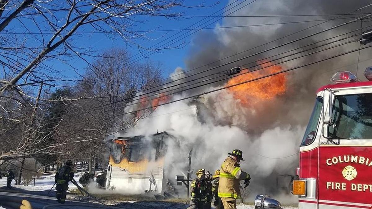 Firefighters try to control a house fire in Clearfield County