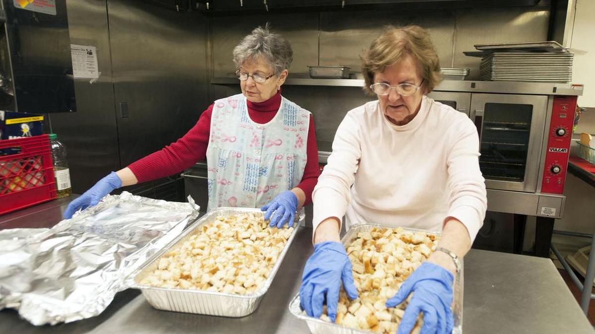 Mamie Reese, left, and Joyce Tedrow prepare the stuffing for the Faith Church’s annual Christmas dinner on Dec 23, 2016 in Bellefonte.