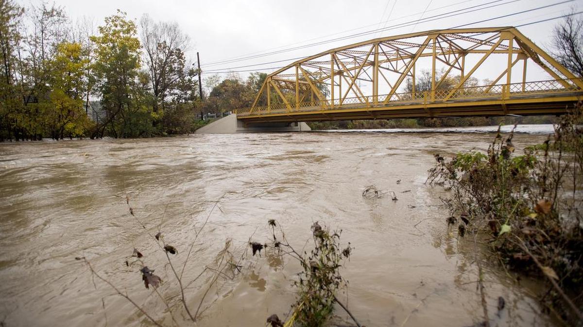 Water rushes down Spring Creek under the Milesburg bridge after heavy and fast rain on Oct. 21.