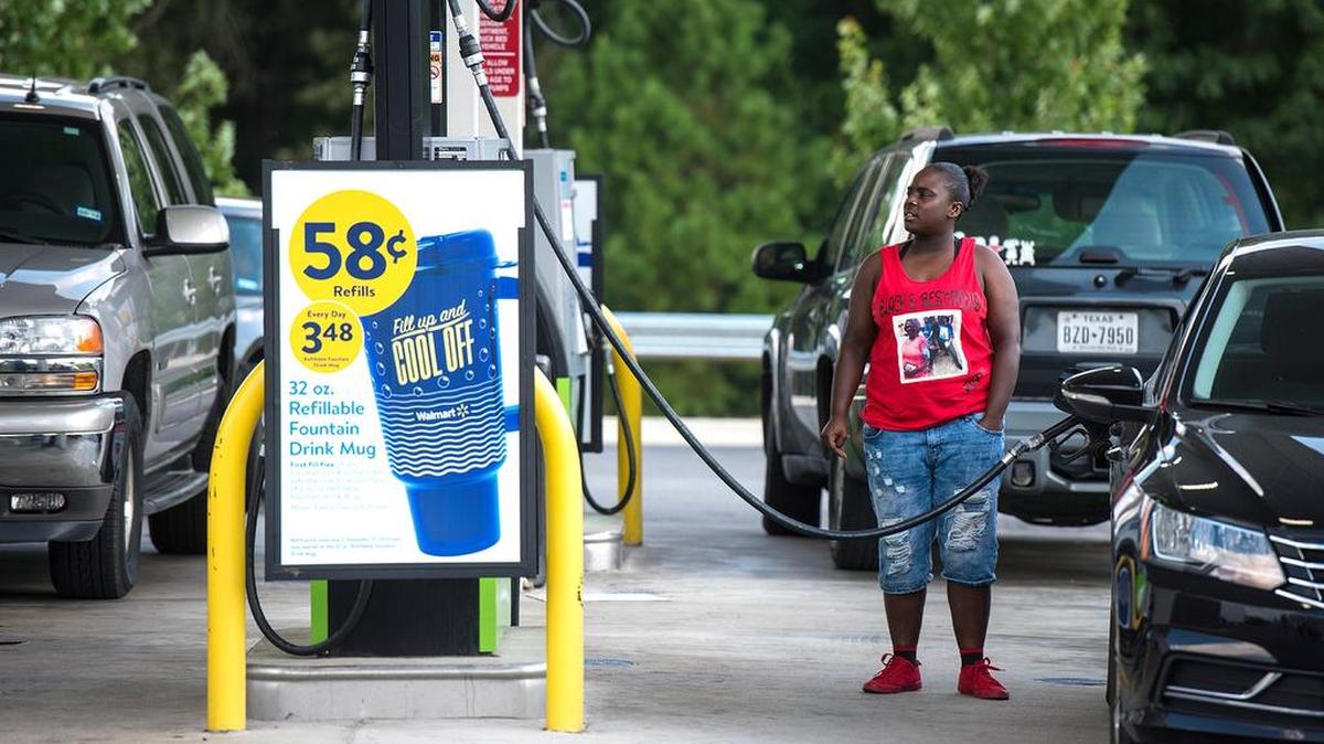 Audranne Williams fills up her car with gas at a Walmart in Tyler, Texas, on Thursday, Aug. 31, 2017. It’s getting harder to fill gas tanks in parts of Texas where some stations are out of fuel and pump costs are spiking in the aftermath of Harvey. (Chelsea Purgahn/Tyler Morning Telegraph via AP)