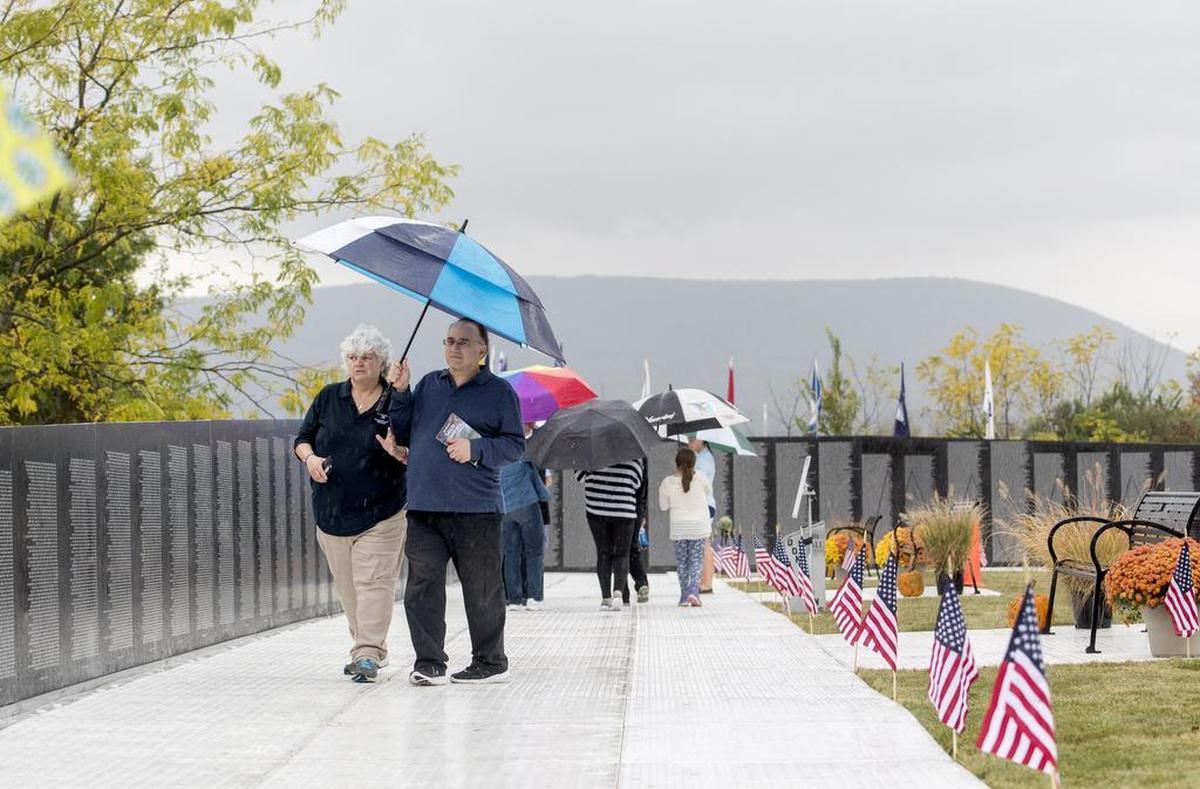 Visitors walk along the Vietnam Veterans Memorial Traveling Wall at Penn State’s Innovation Park on Oct. 5, 2017.