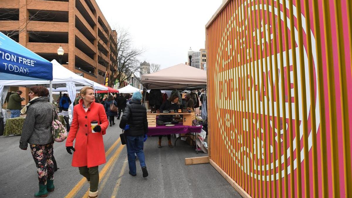 People attend Pop Up Ave Holiday Market Saturday in downtown State College.