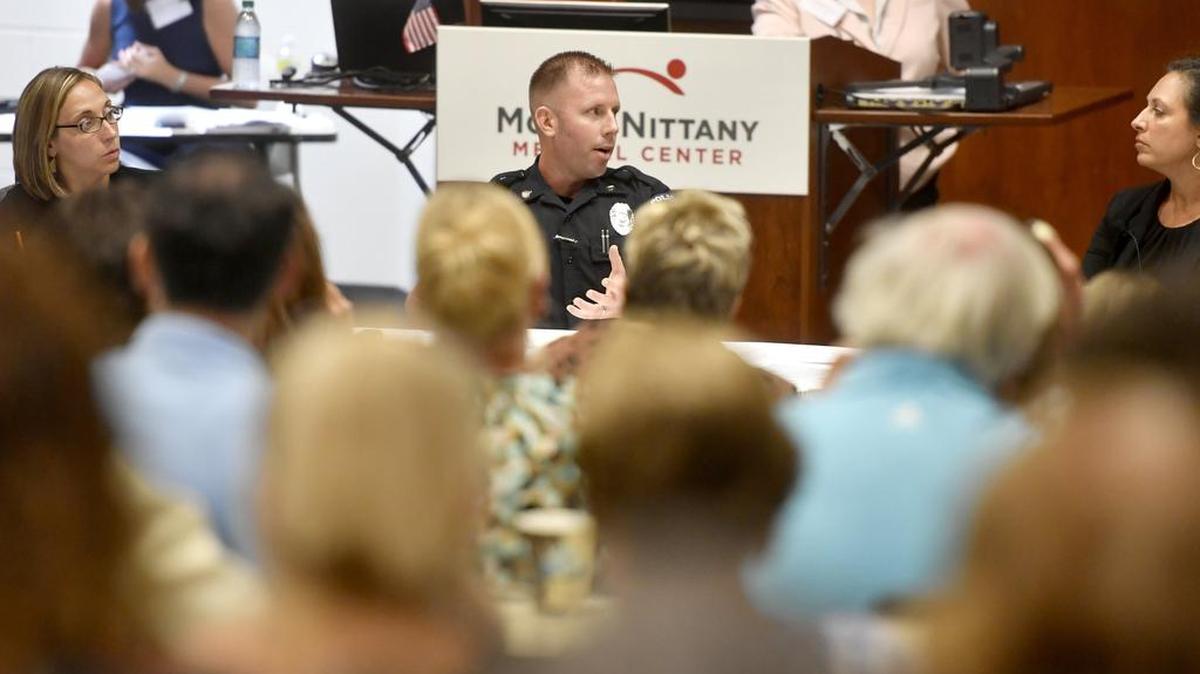 Officer Adam Salyards from the State College Police Department speaks during the town hall for heroin and opioid crisis in Centre County, sponsored by Centre County HOPE Initiative, on Tuesday.