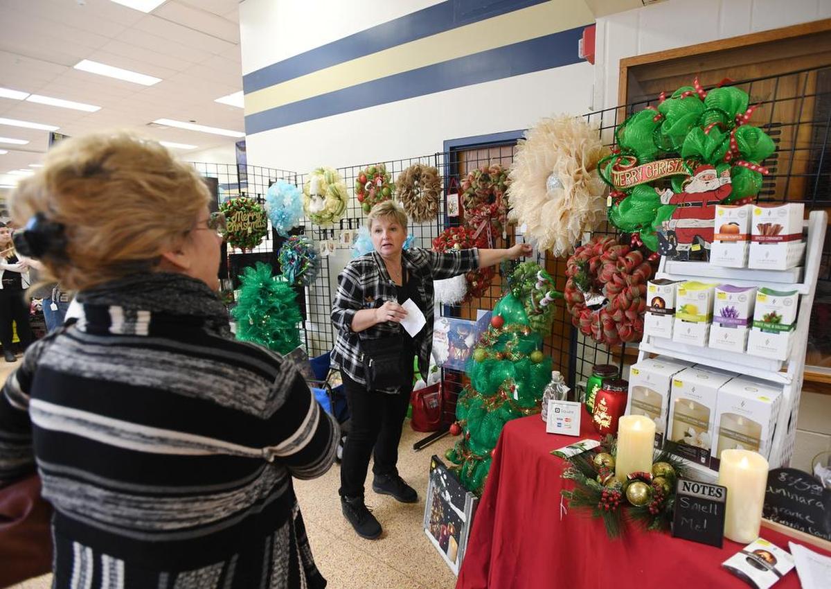 Lori Hartl talks about the different mesh wreaths and trees she makes during the craft fair Saturday at Bald Eagle Area High School.