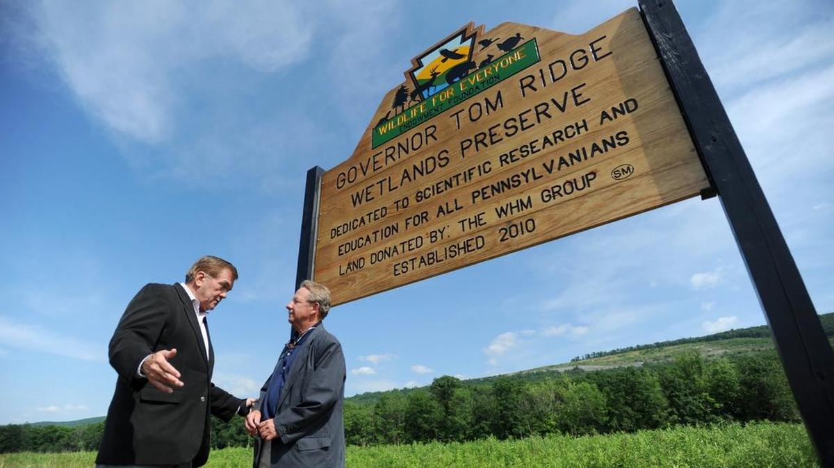 Former Gov. Tom Ridge, left, talks with Michael Schaul, president of The WHM Group, at the dedication of the Gov. Tom Ridge Wetlands Preserve in Houston Township in 2011. The Wildlife for Everyone Endowment Foundation announced plans Tuesday to construct a wildlife center at the preserve.