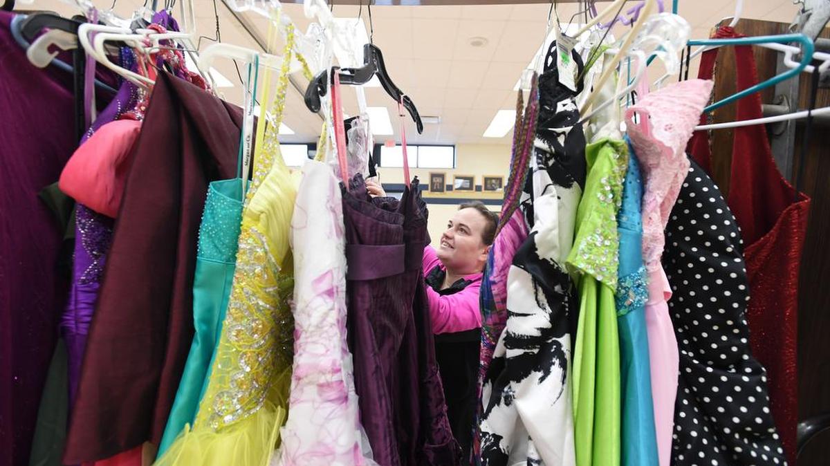 Student government adviser Diane Lucas organizes dresses on Sunday during the Prom and Semi-Formal Dress Event at Bald Eagle Area High School.