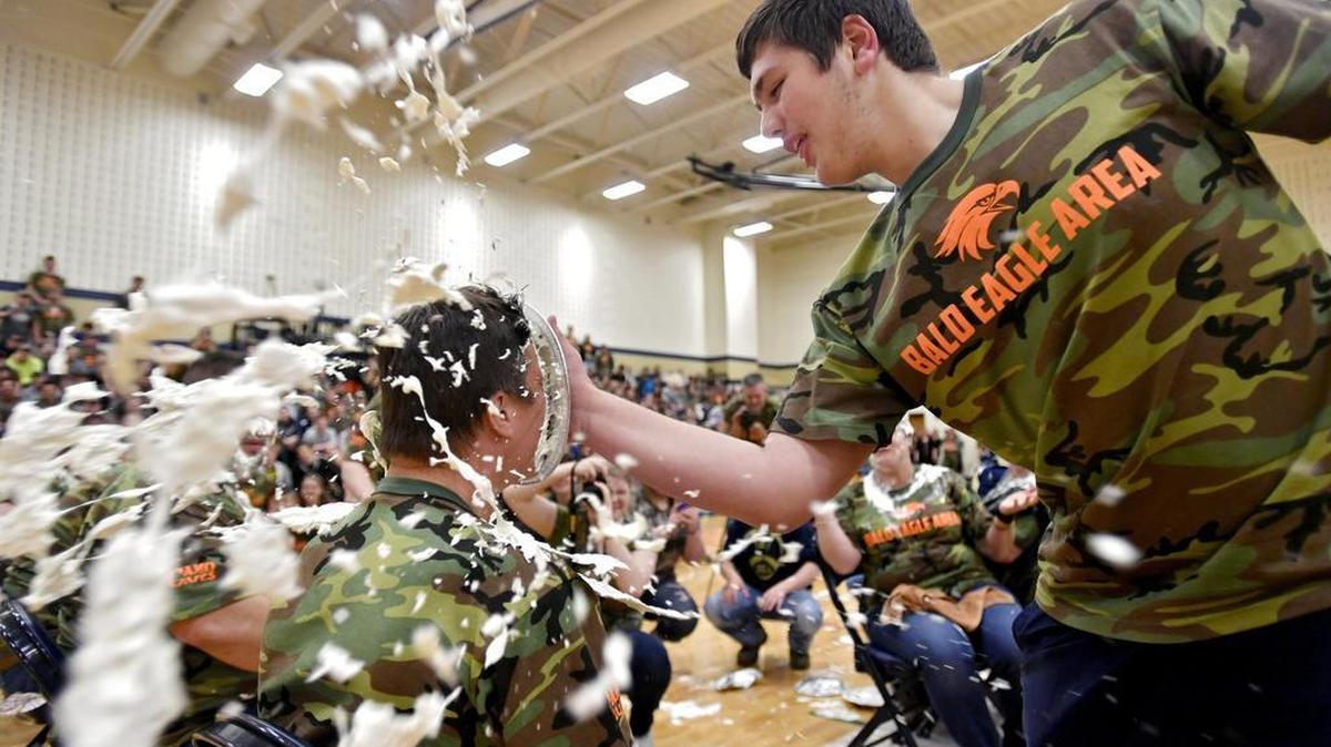 Bald Eagle Area sophomore Cale Burkett pies Superintendent Jeff Miles during the Camo Day assembly on Friday, May 13, 2016. The school raised more than $7,000 for Camo Cares in honor of former student Joe Read.