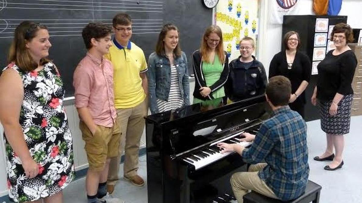 Barry Manilow donated a digital piano to the Bald Eagle Area School District. Michael Bailey played the piano as others listened. He was the first to try it out when the piano arrived earlier this month. Others pictured are high school music and band Director Kellie Long and elementary instrumental music teacher Stephanie Baker, and students from the BEA music program.