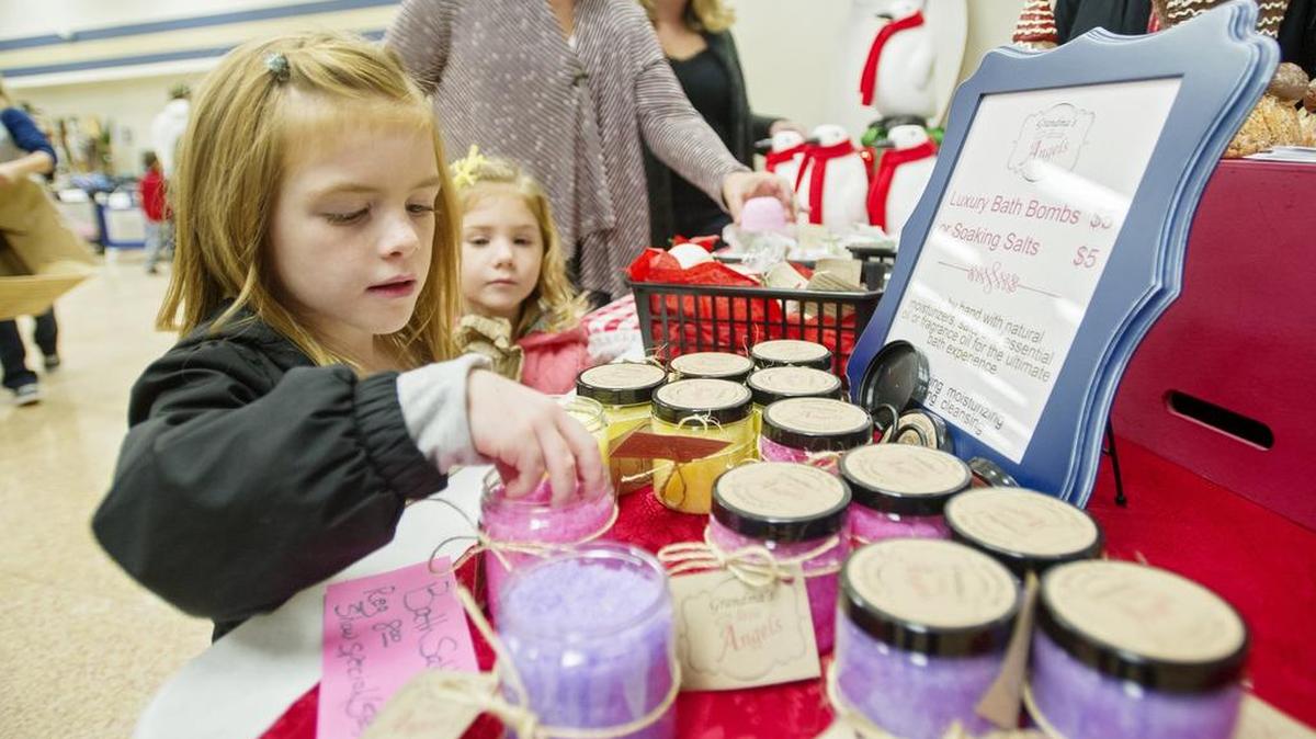 Khloe Evey, 5, and her sister Kylah, 3, smell the Everything Nice soaking salt by Grandma’s Little Angels during last year’s BEA Fall Craft and Gift Fair. This year’s fair will be held from 9 a.m. to 3 p.m. Saturday at Bald Eagle Area High School in Wingate.