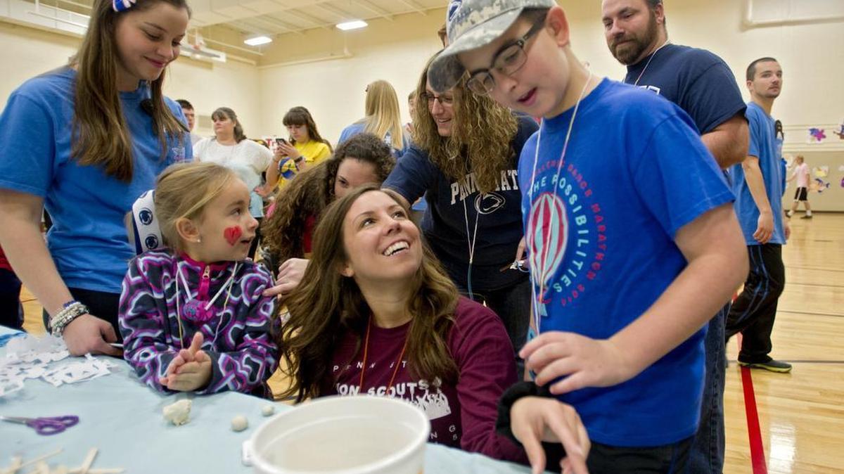 Penn State student Marissa Marino makes a clay snowman with Four Diamonds child Noah Benner, 10, during the Penn State IFC Panhellenic Dance Marathon family carnival on Sunday, December, 6, 2015 at the Intramural Building.