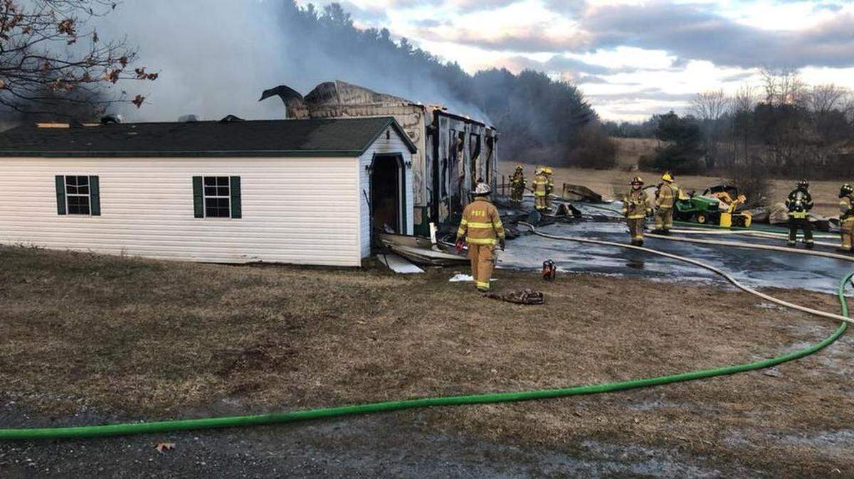 Fire crews respond Friday to a fully involved garage fire at 1015 Purdue Mountain Road in Benner Township.