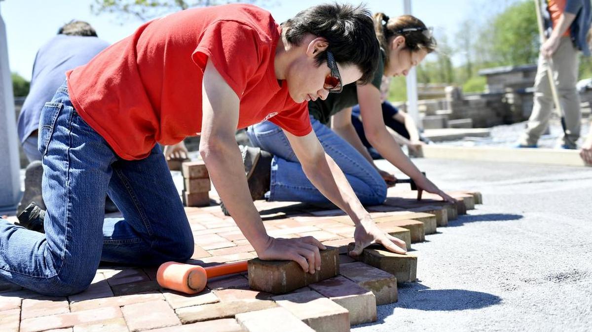 Justin Shaffer helps to lay bricks at the Foster Joseph Sayers Memorial with his classmates from CPI on May 9. Justin graduated from the horticulture and landscaping program at CPI and will graduate from Bellefonte on Wednesday.