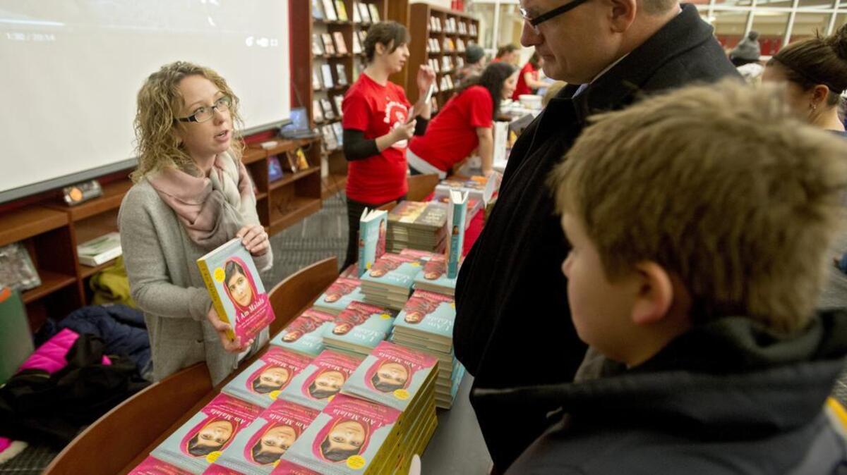 Bellefonte ninth-grade teacher Megan Shirey talks to visitors during Bellefonte Reads’ annual “One Book, One Bellefonte” event Thursday, January 21, 2016, in the Bellefonte High School Library. This year’s program offered a range of reading levels about Nobel Peace Prize winner Malala Yousafzai.