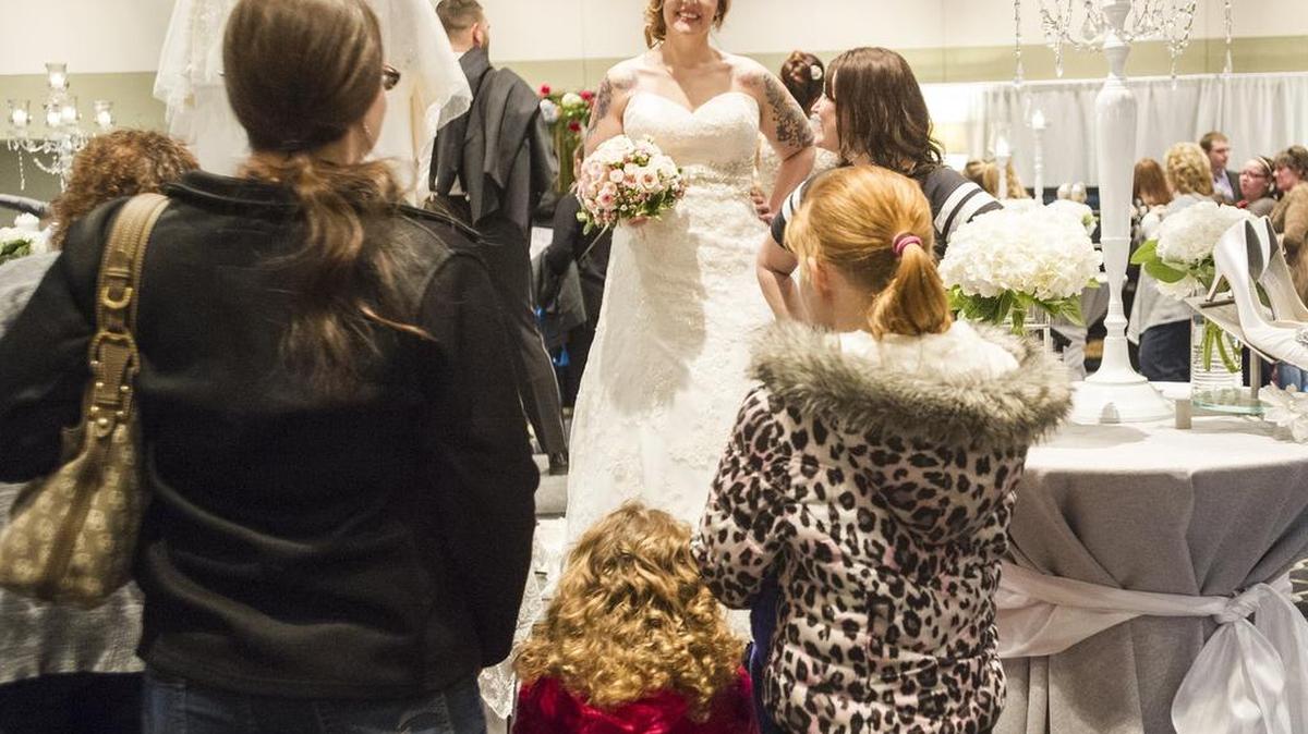 Kendall George, center, models a wedding dress from Bellefonte’s Formalities by Tracina Fisher at the annual Central Pa. Bridal Expo on Sunday. This was George’s fourth year modeling at the expo.