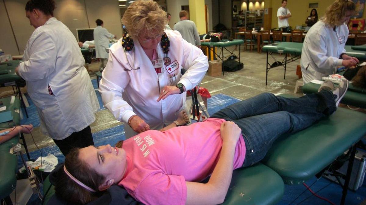American Red Cross worker Caroline Amato prepares to draw blood from Freshman Meghan Gallagher during the Penn State vs. Michigan State Blood Donor Challenge held in the Findlay Commons on the Penn State campus November 10, 2009.