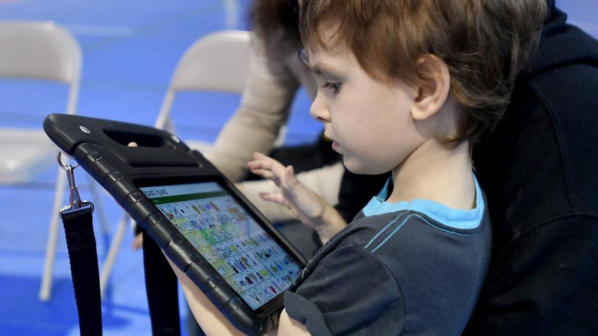 Vincent Tannehill, 6, checks out his new communication device he received from Variety the Children's Charity on Friday.