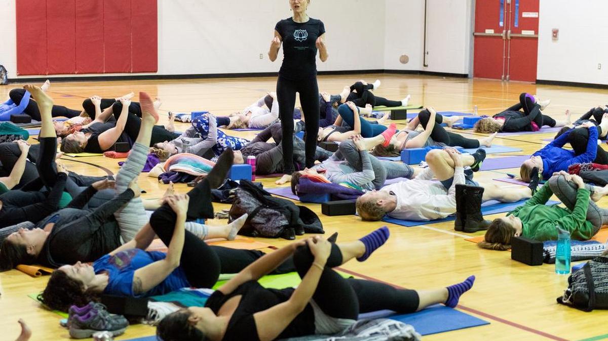 Kate Marshall-Chase leads participants through a warmup during Yoga4Good on Saturday at the State College YMCA. Yoga teachers from around the area joined together to teach the class that benefited the Centre County Women’s Resource Center.