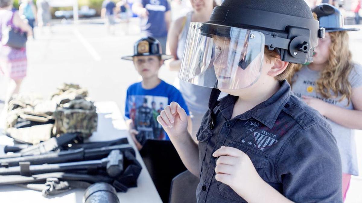 Daniel Patrick tries on a police helmet during the 2017 Patton Township Children’s Fair.