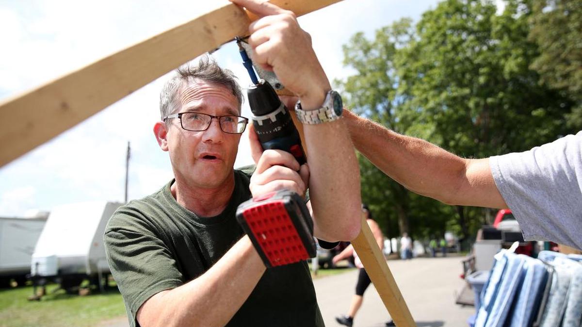 Michael Kelley builds the frame for the kitchen area of the tent during Grange Fair move-in Sunday at the fairgrounds in Centre Hall.