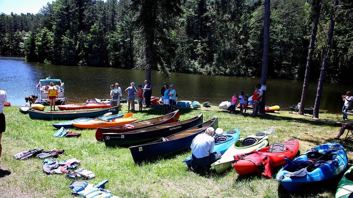 Kayaks and canoes line the shore of Colyer Lake on Sunday for the lake’s official reopening.