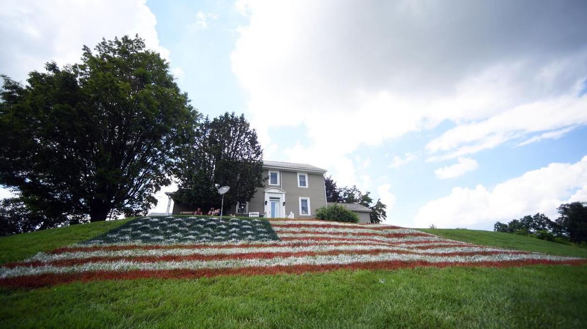 James Button and Doug Mansell spray-painted a 50-foot-wide American flag on Button’s Centre Hall lawn in anticipation for the Fourth of July.