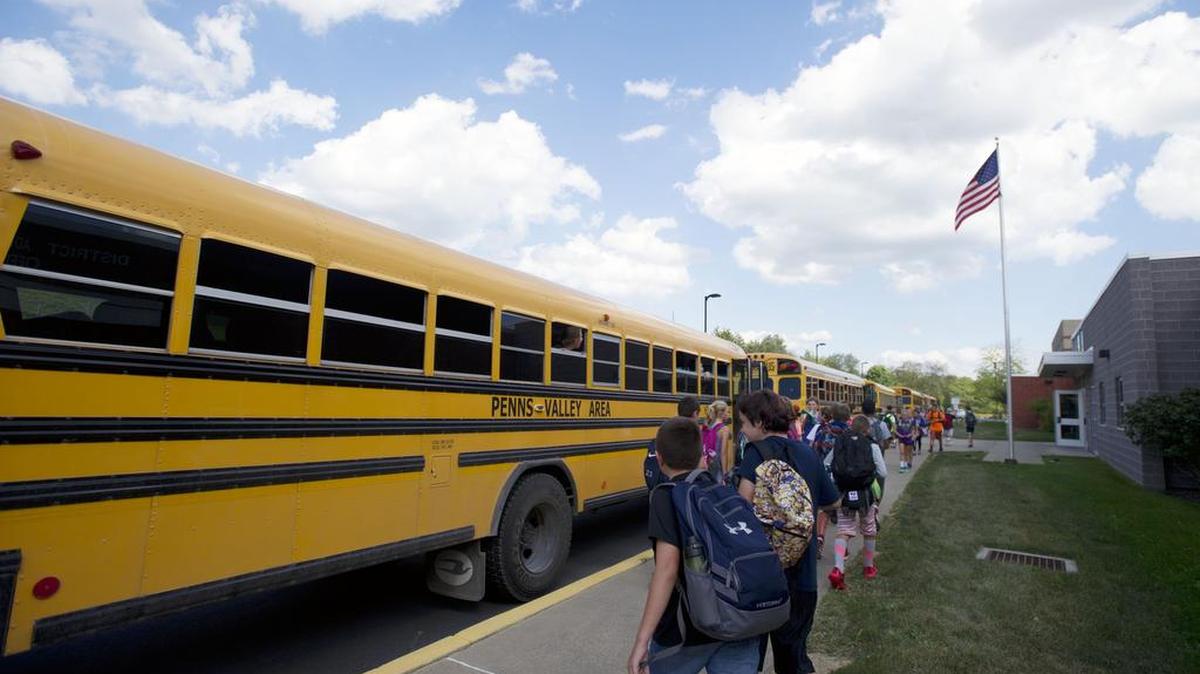 Penns Valley Area Elementary students get on the school bus after school Wednesday. Some parents of students at Sugar Valley Rural Charter School are urging Penns Valley Area School District to change its transportation policy to align with altering school schedules.