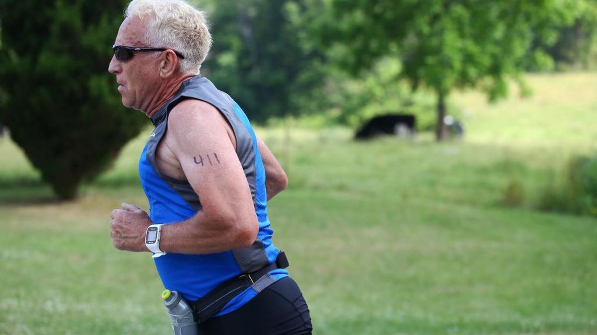 James Polinchok, of Port Matilda, runs down Park Entrance Road in Millhiem for the final stretch of the 5K portion of the Millhiem Pool Triathlon on Saturday.