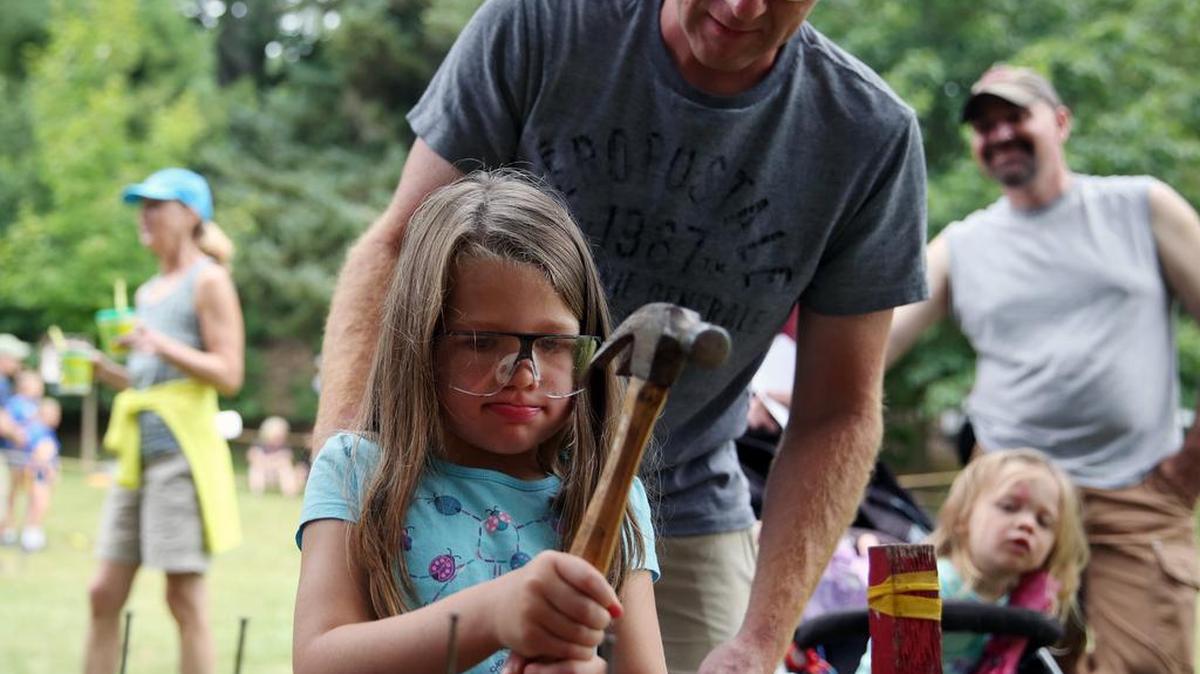 David Kessling helps his daughter, Alyssa Kessling, 4, hammer nails into a log for the nail pound competition during the 32nd annual Friends of Black Moshannon Summer Festival Saturday, July 22, 2017 at Black Moshannon State Park.