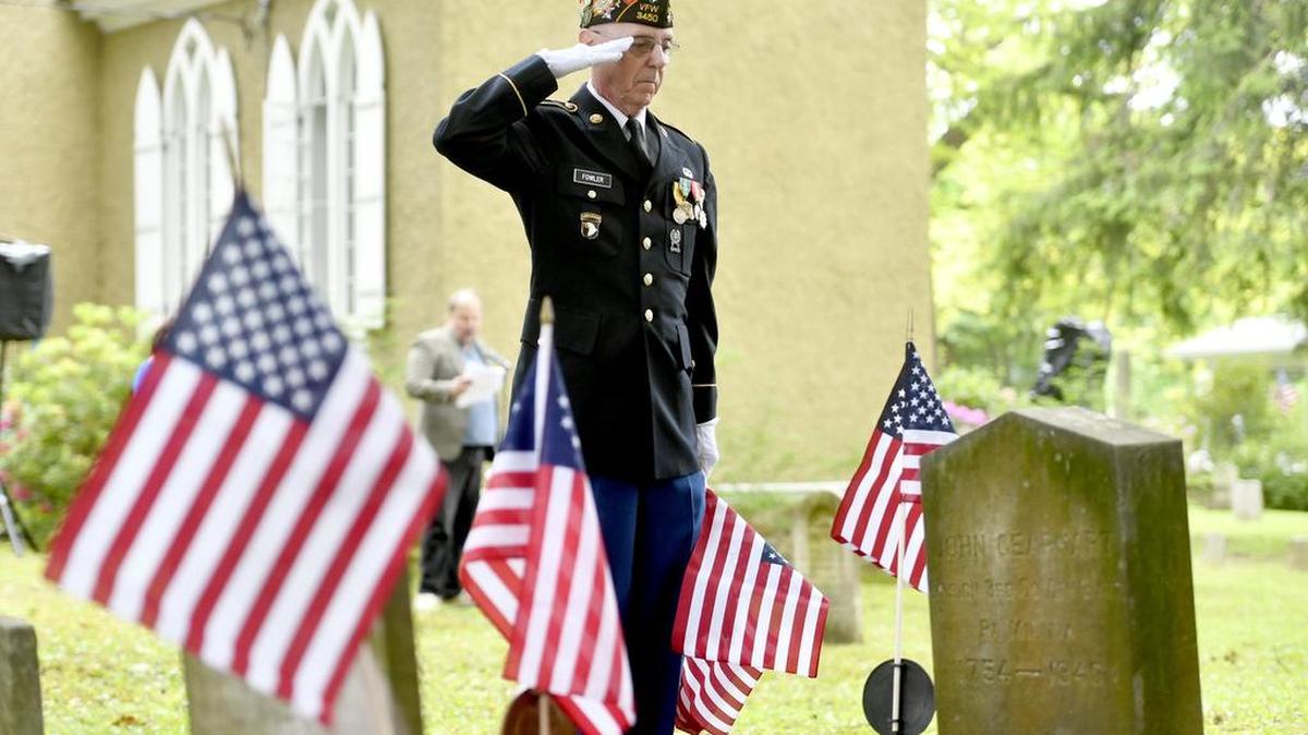 Russell Fowler salutes the grave of John Gearhart after placing an American flag next to it during Sunday’s Ecumenical Memorial Day Worship at Union Church in Philipsburg. Gearhart’s headstone reads 3rd Co 4th Batt PA Militia 1754-1840.