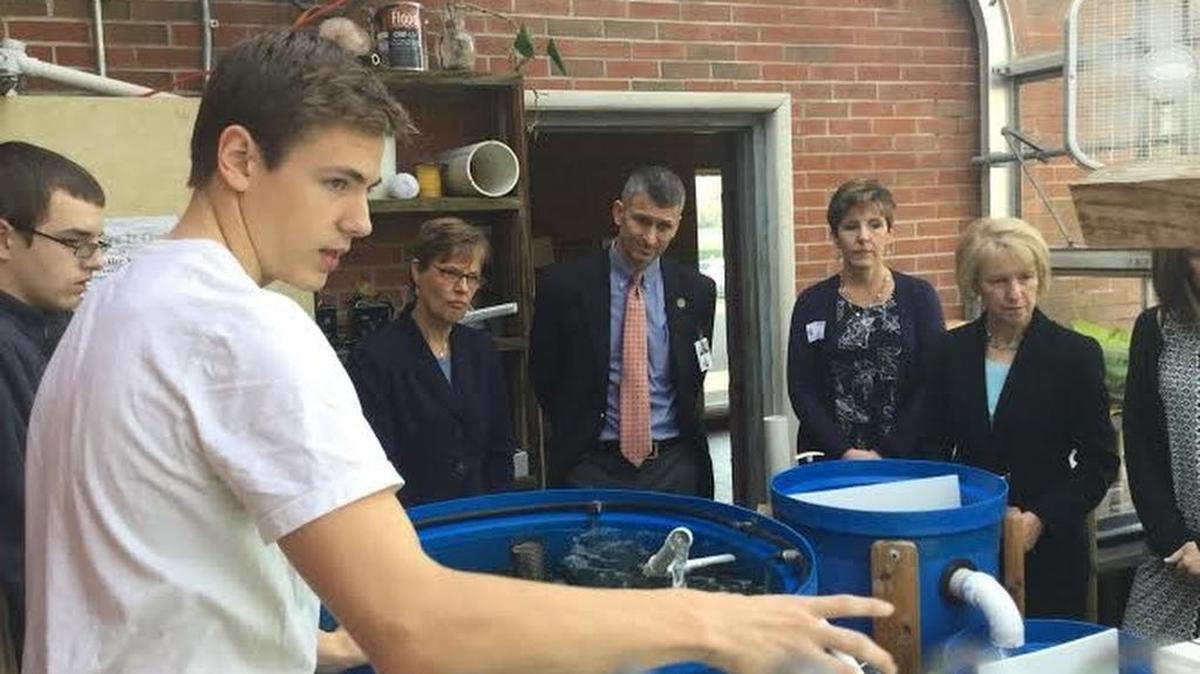 State College Area High School junior Gabe Avillian gives a tour of biology teacher Jack Lyke’s Aquaponics room. Aquaponics is an agricultural method that combines the use of fish with hydroponics to grow plants. Pictured are also USDA deputy Katie Wilson, Superintendent Bob O’Donnell, Elaine McDonnell from Project PA, and USDA regional administrator Patricia Dombroski.
