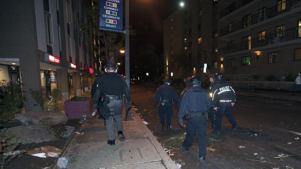 Police patrol East Beaver Avenue in the wake of a riot that broke out after the Penn State game Saturday.