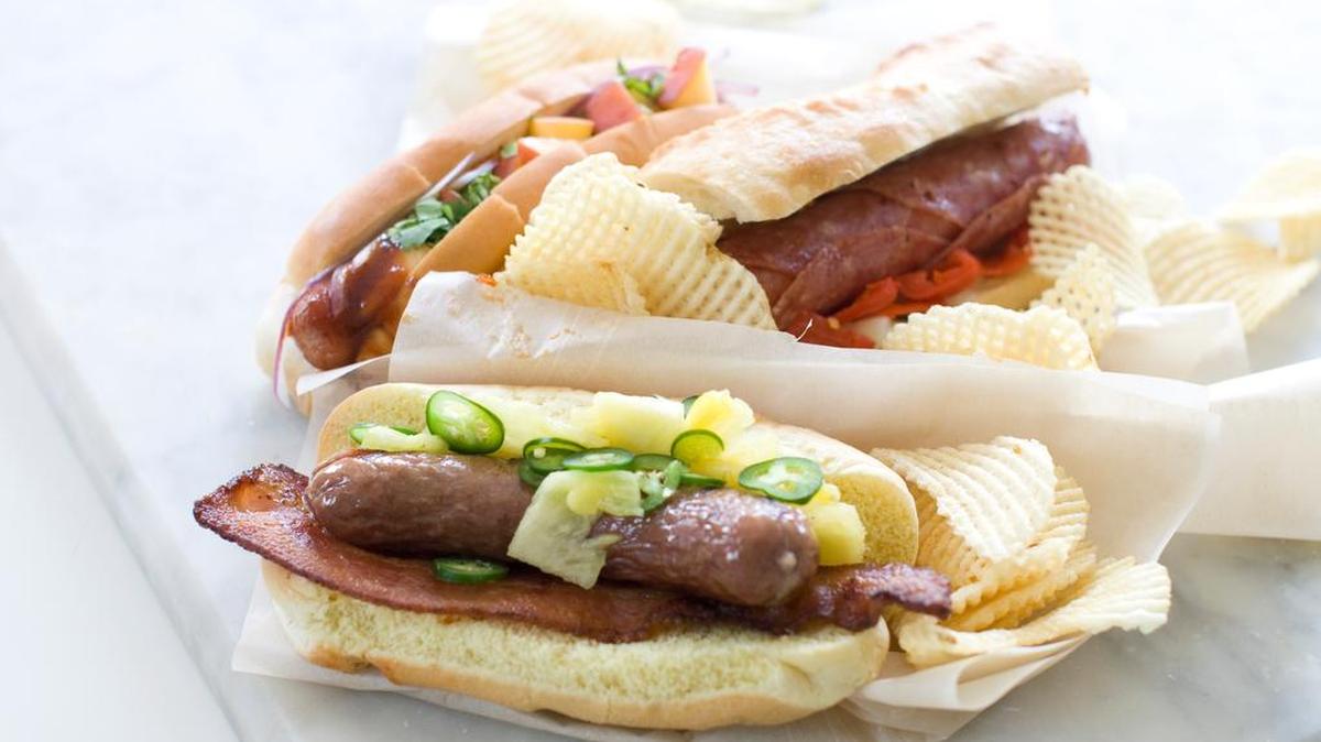 This June 29, 2013 photo shows, from top left, the sweet peach, Italian and Hawaiian hot dogs in Concord, N.H. (AP Photo/Matthew Mead)