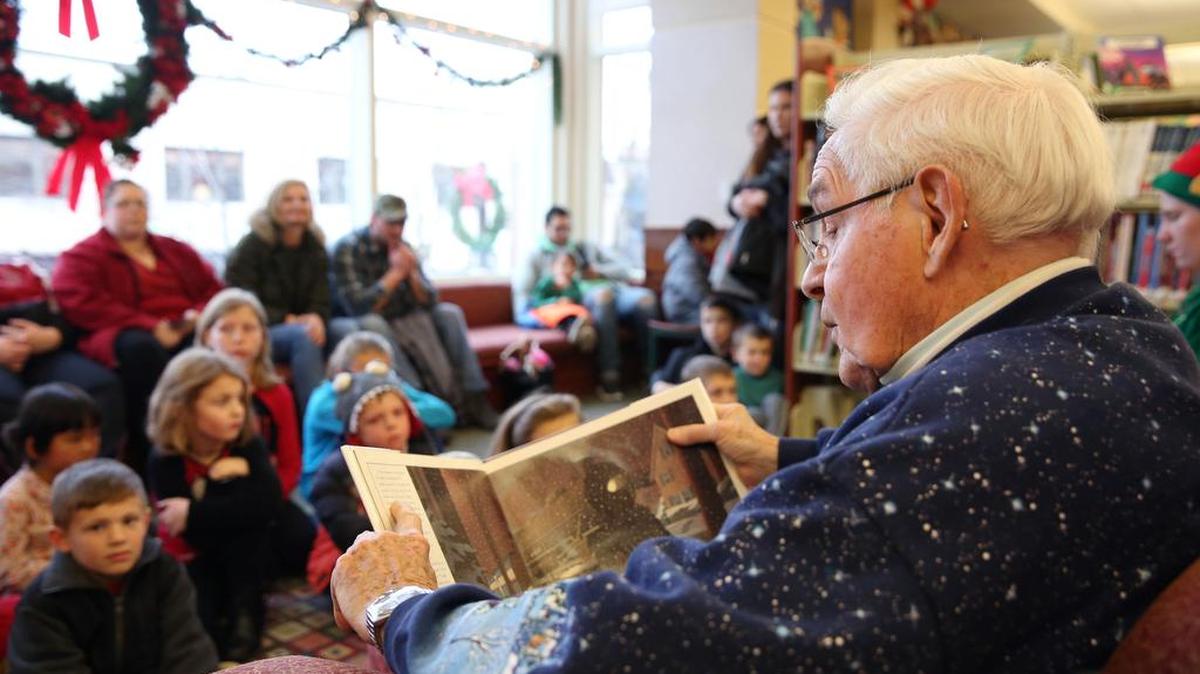 Wayne Britten reads “The Polar Express” to children and their families Sunday at Schlow Centre Region Library.