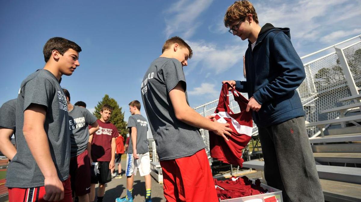 Isaac Messner shows his teammates the new uniforms. State High senior Isaac Messner was granted a wish from Make-A-Wish Greater Pennsylvania and West Virginia. Messner, a member of the State College Area High School track and field team, chose to get new uniforms for his teammates instead of something for himself March 23, 2016.