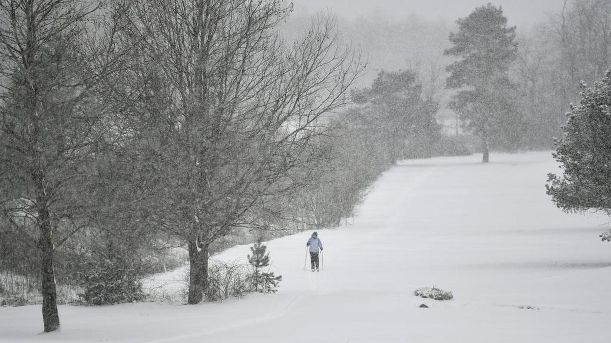 A woman cross-country skies along the Penn State golf courses as snow coats Centre County on Wednesday, March 21, 2018.