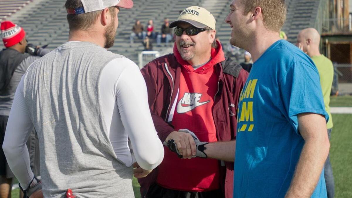 State College defensive coach Mike Snyder shakes hands with former players during the “Sweet Potato Classic” on Friday, November 27, 2015, at Memorial Field. State College football alumni gathered for the 5 on 5 tournament to raise money for scholarships for current players.