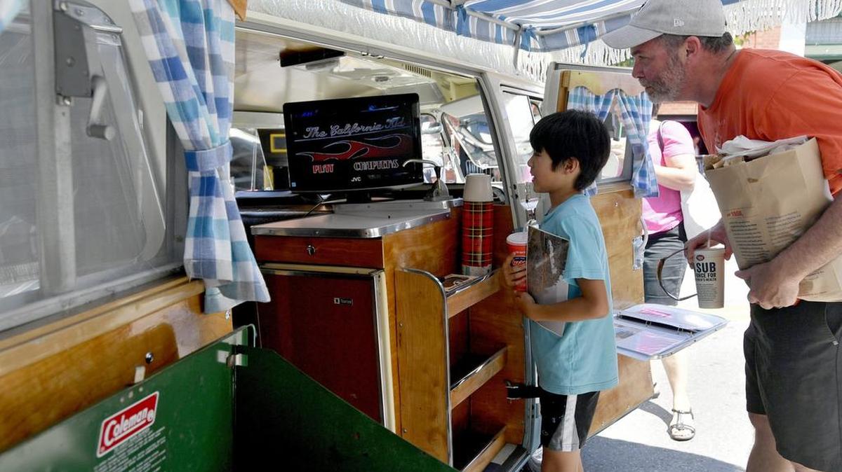 Ben Housley, 11, admires the inside of Delmar Baker’s 1967 Volkswagen bus during the Last Cruise to benefit the Centre County Youth Service Bureau on Sunday, July 30, 2017 along South Allen Street in downtown State College.