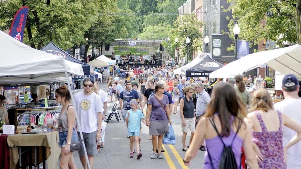 Visitors walk through the street sales on Allen Street during the Summer's Best Music Fest in 2013. This year, the event has been renamed Happy Valley Music Fest.